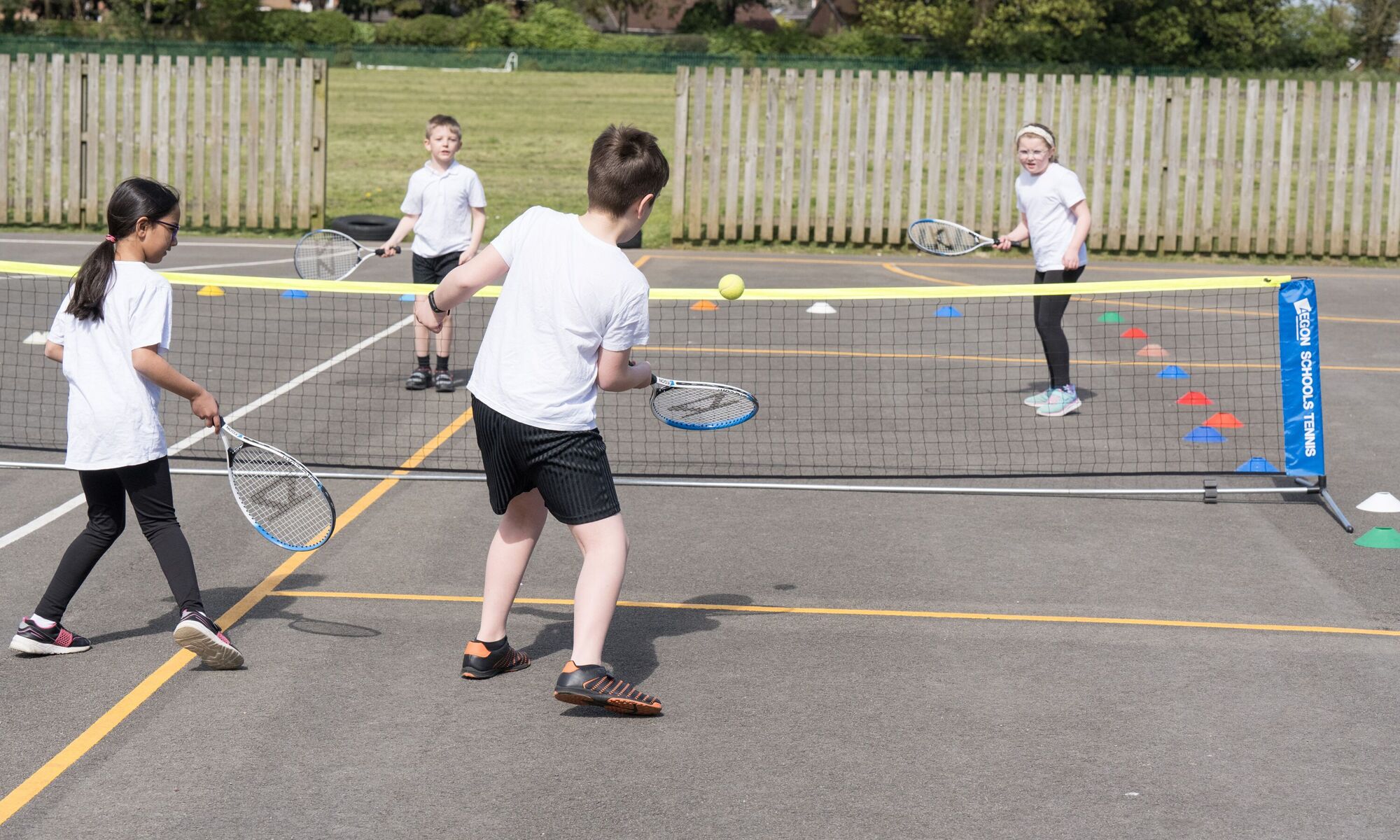 Starbeck Primary Academy - for pupils playing tennis outside in white uniform